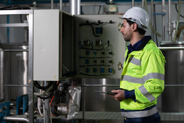 istock engineer or factory worker looking and operating machine control panel in factory 1326027865
