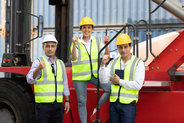 istock factory workers or engineer team raise hands pose for successful job in containers warehouse storage 1326028284