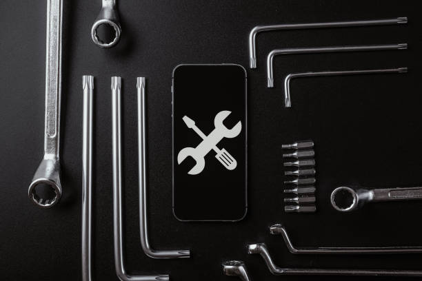 istock Mobile repair service. Technician workplace with phone and special repairing tools. Electronics repair service, device production concept. 1326029889