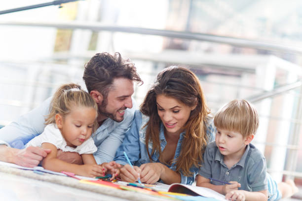 istock Happy parents drawing with their small kids at home. 1326030537