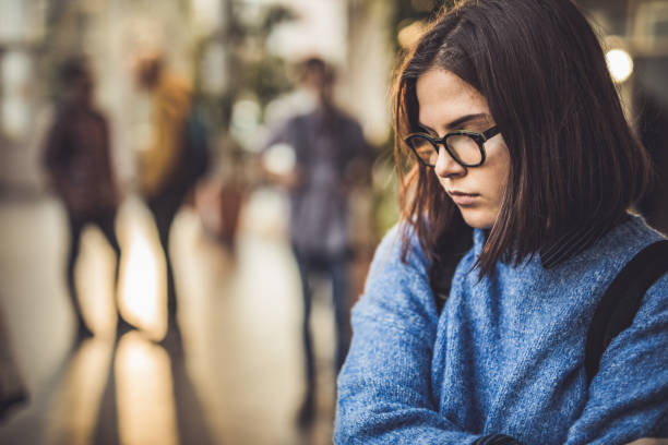 istock Sad high school student feeling lonely in a hallway. 1326030878