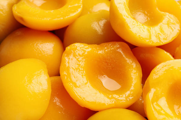 Halves of canned peaches as background, closeup Halves of canned peaches as background, closeup compote photos stock pictures, royalty-free photos & images
