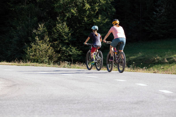 istock Mother and daughter riding mountain bikes in nature 1326031100