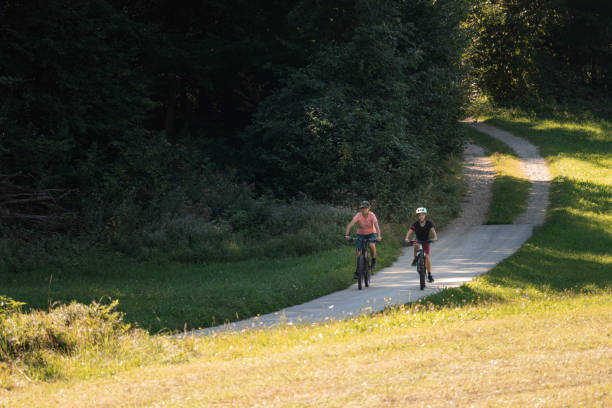 istock Mother and daughter riding mountain bikes in nature 1326031154