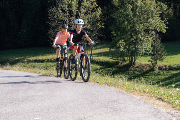 istock Mother and daughter riding mountain bikes in nature 1326031784