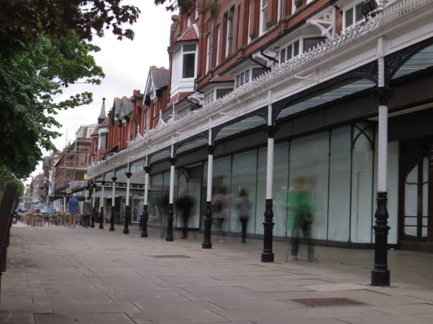 istock Shoppers walk past abandoned  shop fronts 1326032962