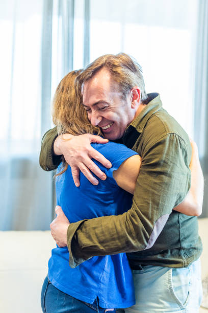 istock Mature man and woman hugging at home. 1326034443