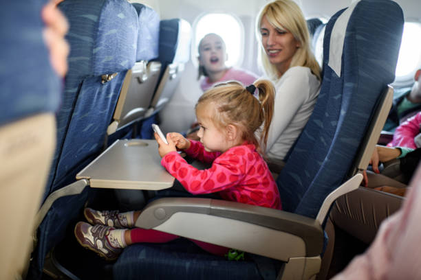 istock Small girl using smart phone while traveling with her mother. 1326035107