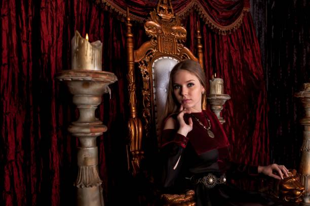 istock Medieval queen in historical attire on golden throne in castle 1326035250