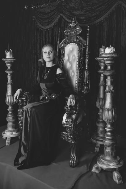 istock Medieval queen in historical attire on golden throne in castle 1326035260