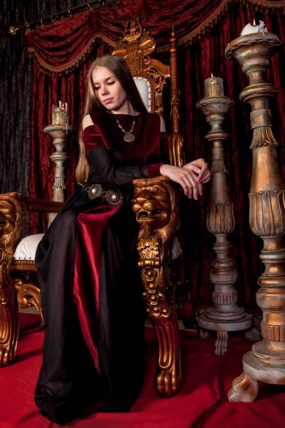 istock Medieval queen in historical attire on golden throne in castle 1326035262