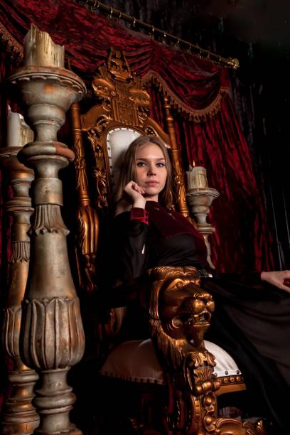 istock Medieval queen in historical attire on golden throne in castle 1326035280