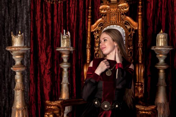 istock Medieval queen in historical attire on golden throne in castle 1326035281