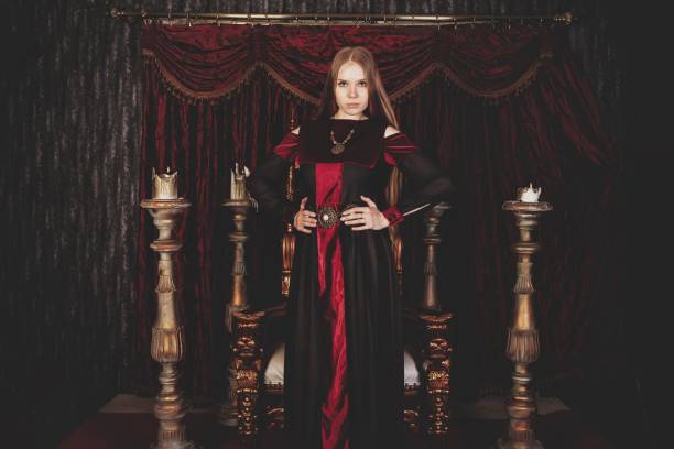 istock Medieval queen in historical attire on golden throne in castle 1326035300