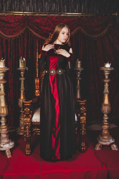 istock Medieval queen in historical attire on golden throne in castle 1326035301