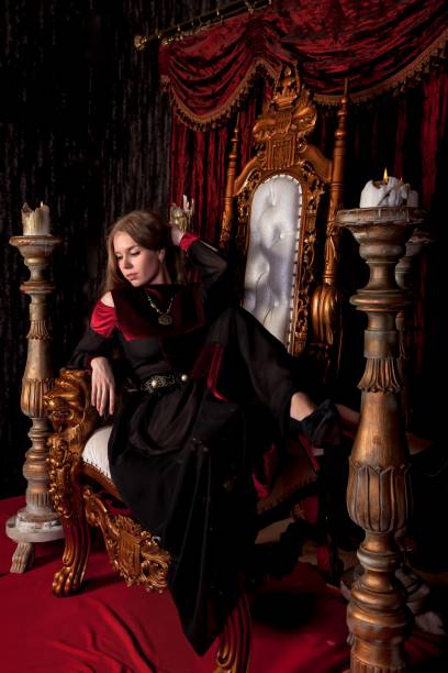 istock Medieval queen in historical attire on golden throne in castle 1326035306