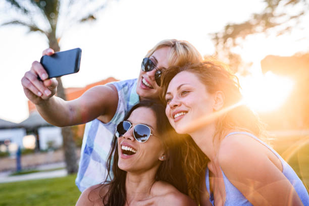 istock Happy women taking a selfie with smart phone in nature. 1326035356