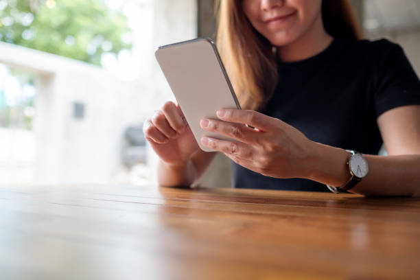 istock a beautiful young asian woman holding and using mobile phone 1326035437