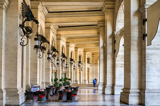 Rome, Italy, June 11 -- The elegant arcade of Piazza della Repubblica (Republic Square), in the heart of the historic center of Rome, in one of the most known and visited districts of the Italian capital at border of the Monti district. The porticoed buildings that surrounded the square were built between 1887 and 1898 by the architect Gaetano Koch. Piazza della Repubblica is located in the area of the Baths of Diocletian, the most impressive spa area of ancient Rome, and the central Via Nazionale boulevard. This area of the city is also famous for the presence of numerous luxury hotels and high fashion shops. Image in high definition format.