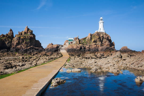 Corbiere Lighthouse on Jersey Corbiere Lighthouse on Jersey, The Channel Islands channel islands england stock pictures, royalty-free photos & images