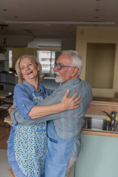 istock Older Couple is Enjoying at Home while Preparing a Delicious Meal and Dancing. Love Never Grows Old. 1326039185