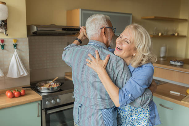 istock Elderly Couple Enjoying in Dance While Cooking at Home. 1326039208