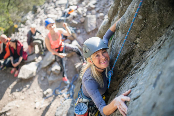 istock Group of seniors with instructor climbing rocks outdoors in nature, active lifestyle. 1326040008