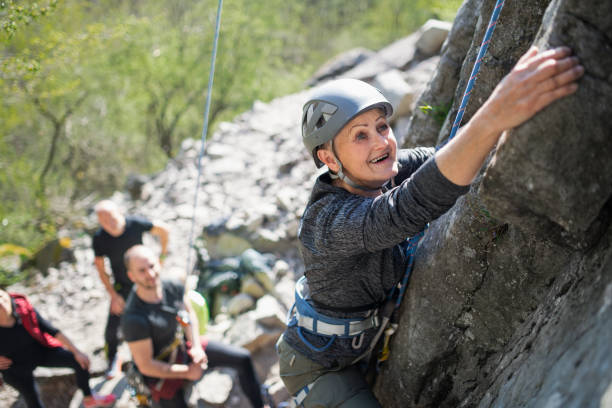 istock Group of seniors with instructor climbing rocks outdoors in nature, active lifestyle. 1326040025