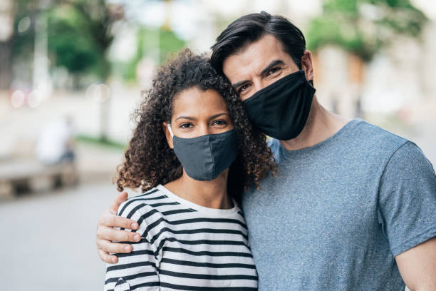 istock Portrait of young couple with protective mask 1326040154