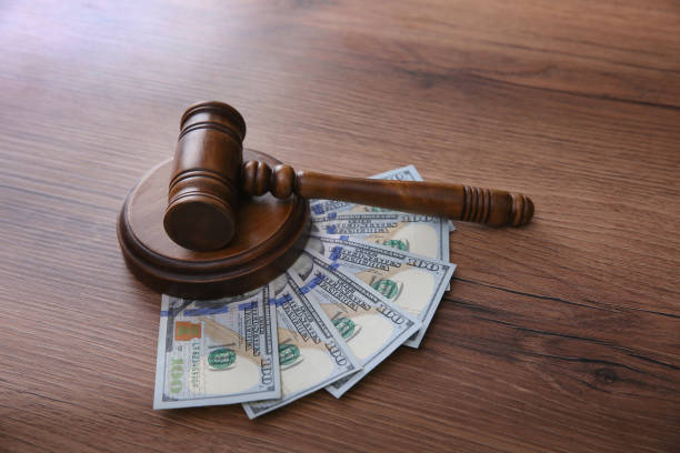 istock Judge's gavel and money on wooden table 1326040985