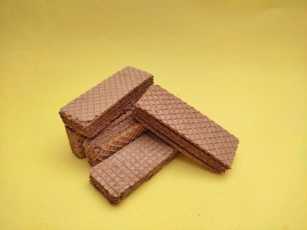 istock Crunchy chocolate wafers isolated on yellow background 1326041510