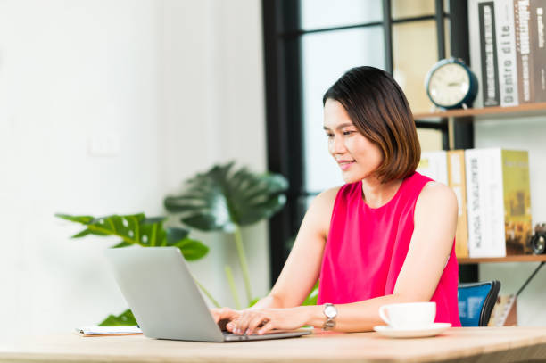 istock A middle-aged Asian woman work at home office check information online using laptop 1326041782