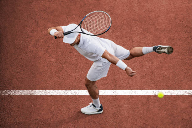 Tennis Sport. Top view of male tennis player hitting ball with racket. tennis stock pictures, royalty-free photos & images