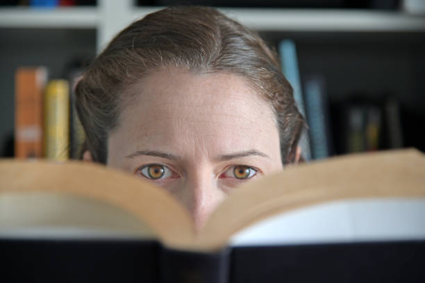 Woman reading a book in library