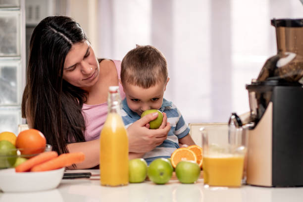 istock Family in the kitchen make fresh juice 1326042876