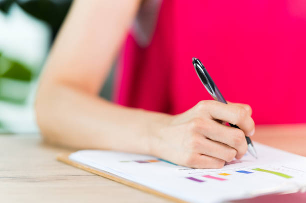 istock A middle-aged Asian woman Signing Contract, Working In Office 1326044180