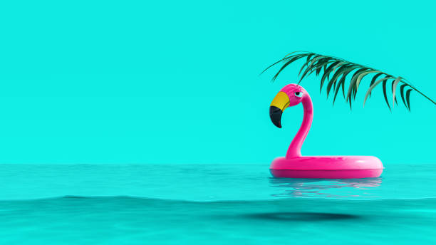 istock Pink flamingo floating in water on turquoise blue summer background 1326044592