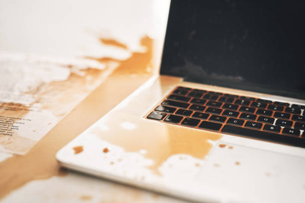 istock Shot of coffee spilt over a laptop 1326045437