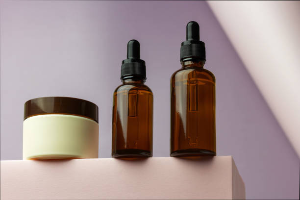 istock Composition with bottles of essential oils and cream jar packaging on a pink background. 1326045547
