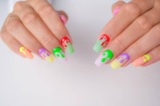 istock Women's hands with a beautiful summer manicure on a white background. The nails are covered with a gel polish with a design. 1326046139