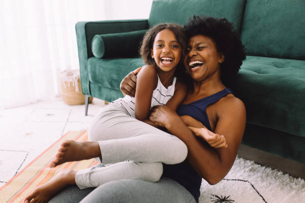 istock Mother and daughter enjoying at home after workout session 1326047665