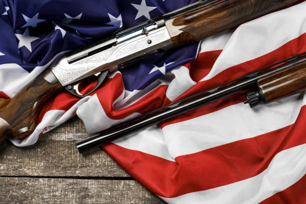 istock Automatic rifle on USA flag on wooden background 1326048559