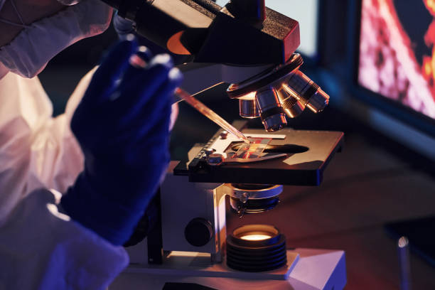 istock Scientist in white protective uniform works with coronavirus and blood tubes in laboratory 1326048616