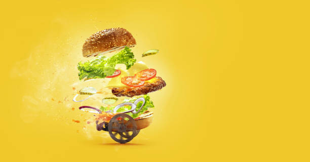 istock Hamburger with flying ingredients on yellow studio background. Fast food, cuisine and express delivery concept. 1326049146