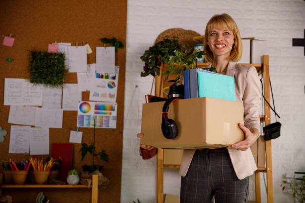 confident businesswoman walking into her new office - finishing employment issues occupation downsizing imagens e fotografias de stock