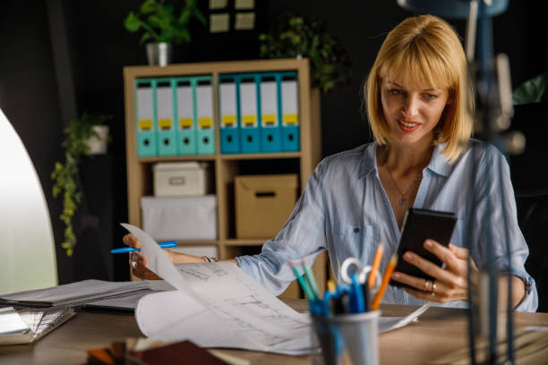istock Female architect checking text messages on her smart phone 1326050007
