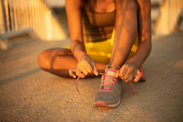 istock Sportswoman Tying Shoelaces. 1326051303