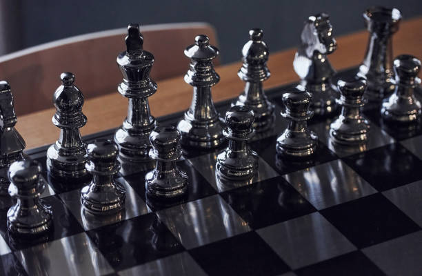 istock Chess board with metal figures on it indoors on the table at daytime 1326051675
