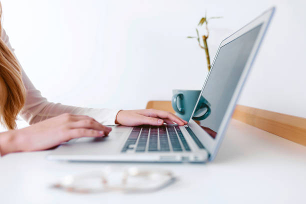 istock Unknown woman working with laptop 1326051788