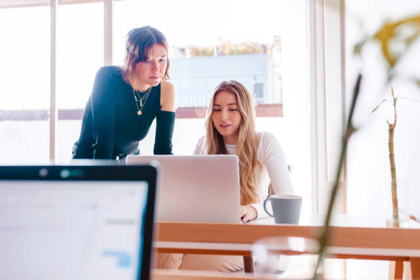 istock Two young women working with laptop at the office 1326051790